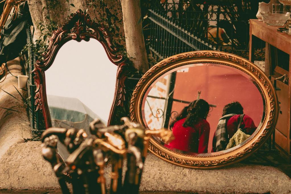 women reflecting in retro mirror